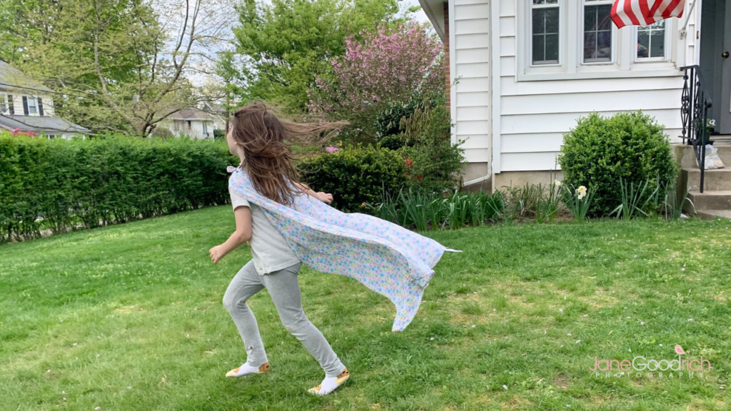 girl running in yard with cape Jane Goodrich Photography Larchmont, NY