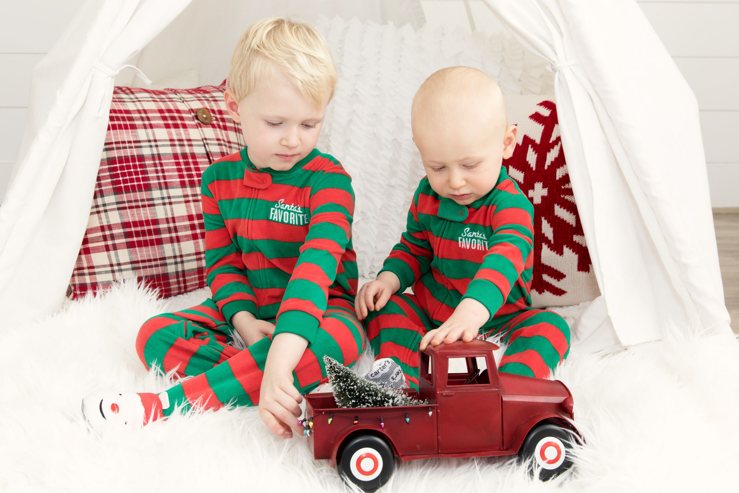 in studio holiday photo shoot siblings in Christmas pjs