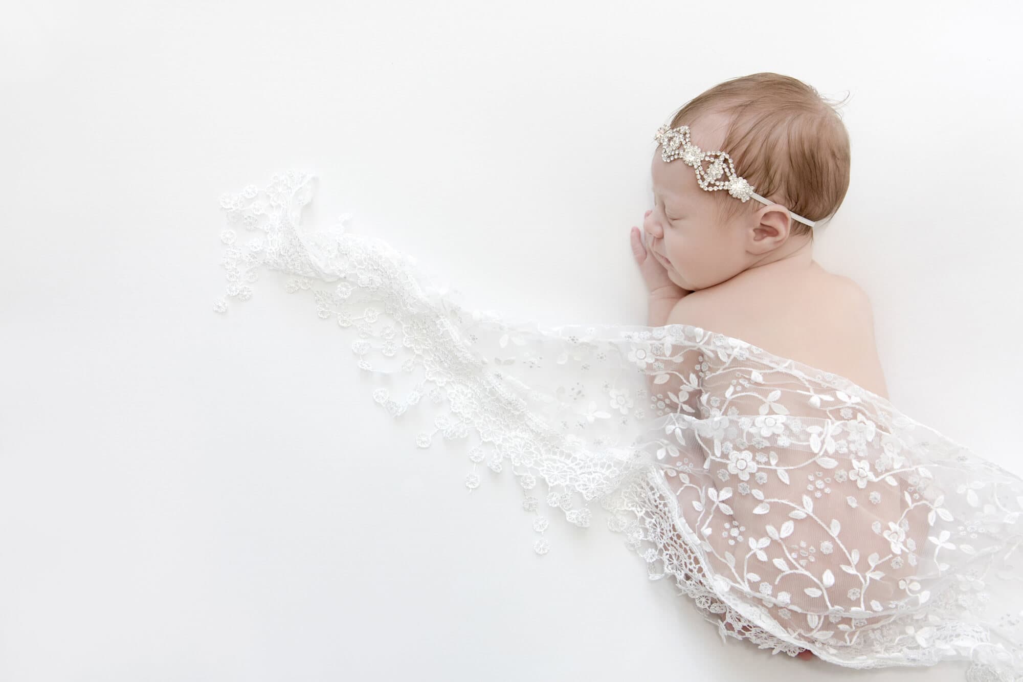 newbornn portrait photograph baby girl in white lace wrap
