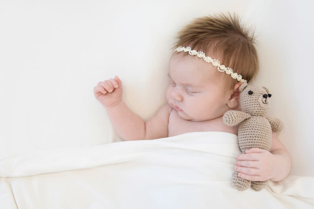 newborn baby studio photography with teddy bear