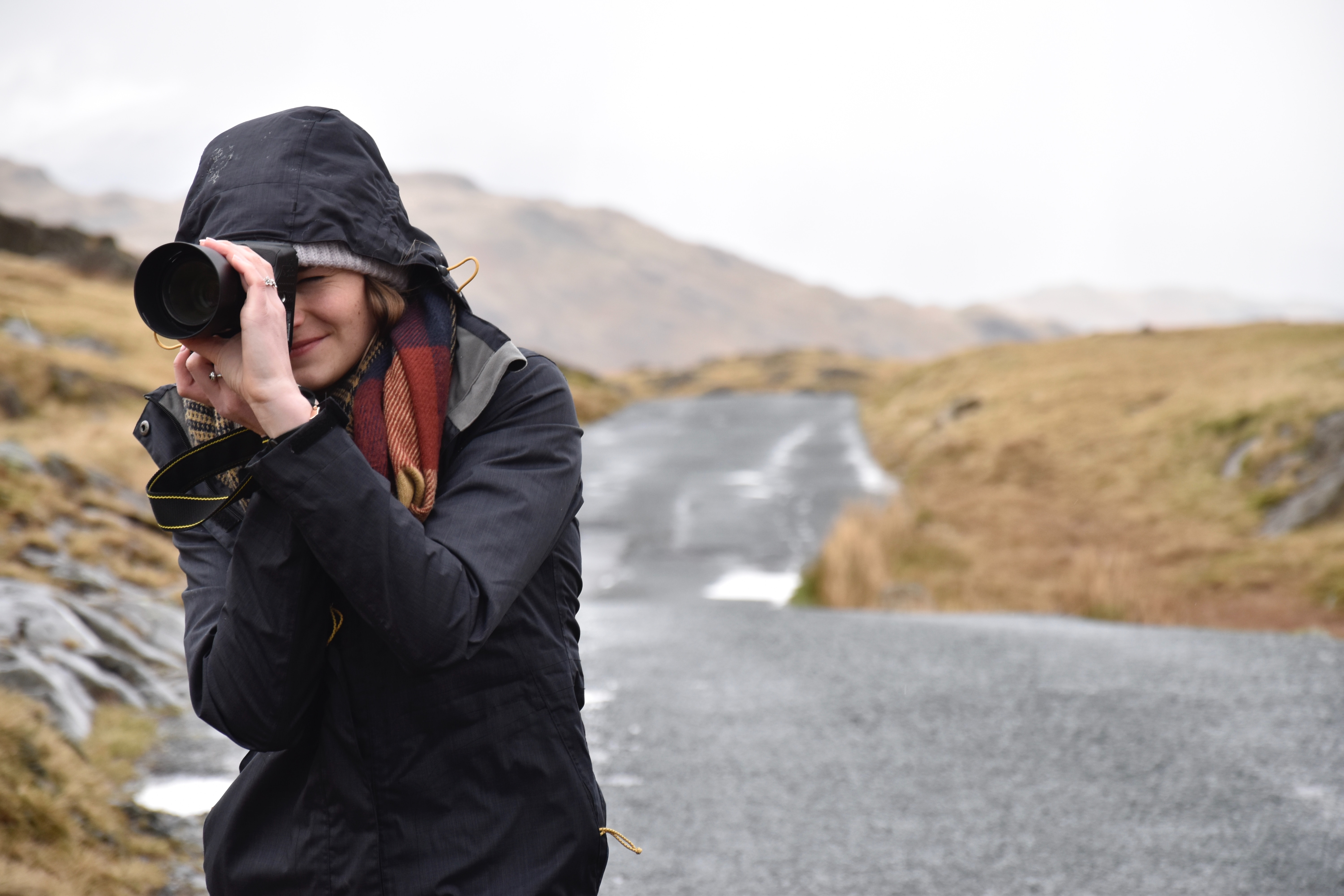 woman taking photo in the rain